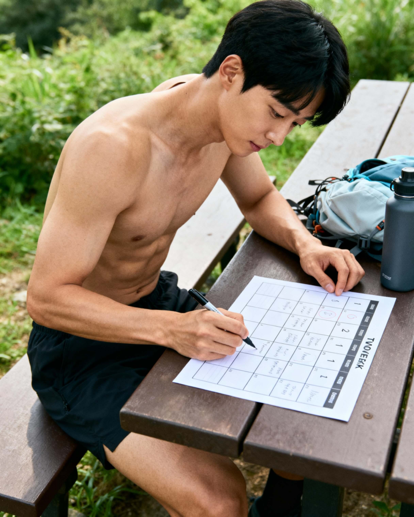 Beginner hiker marking workouts and rest days on a simple hiking training schedule.