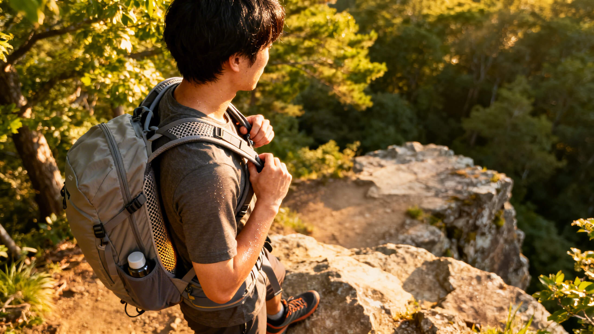 Hiker adjusting a breathable lightweight daypack with ventilated back panel on a warm summer trail, demonstrating proper fit and airflow for day hiking comfort.