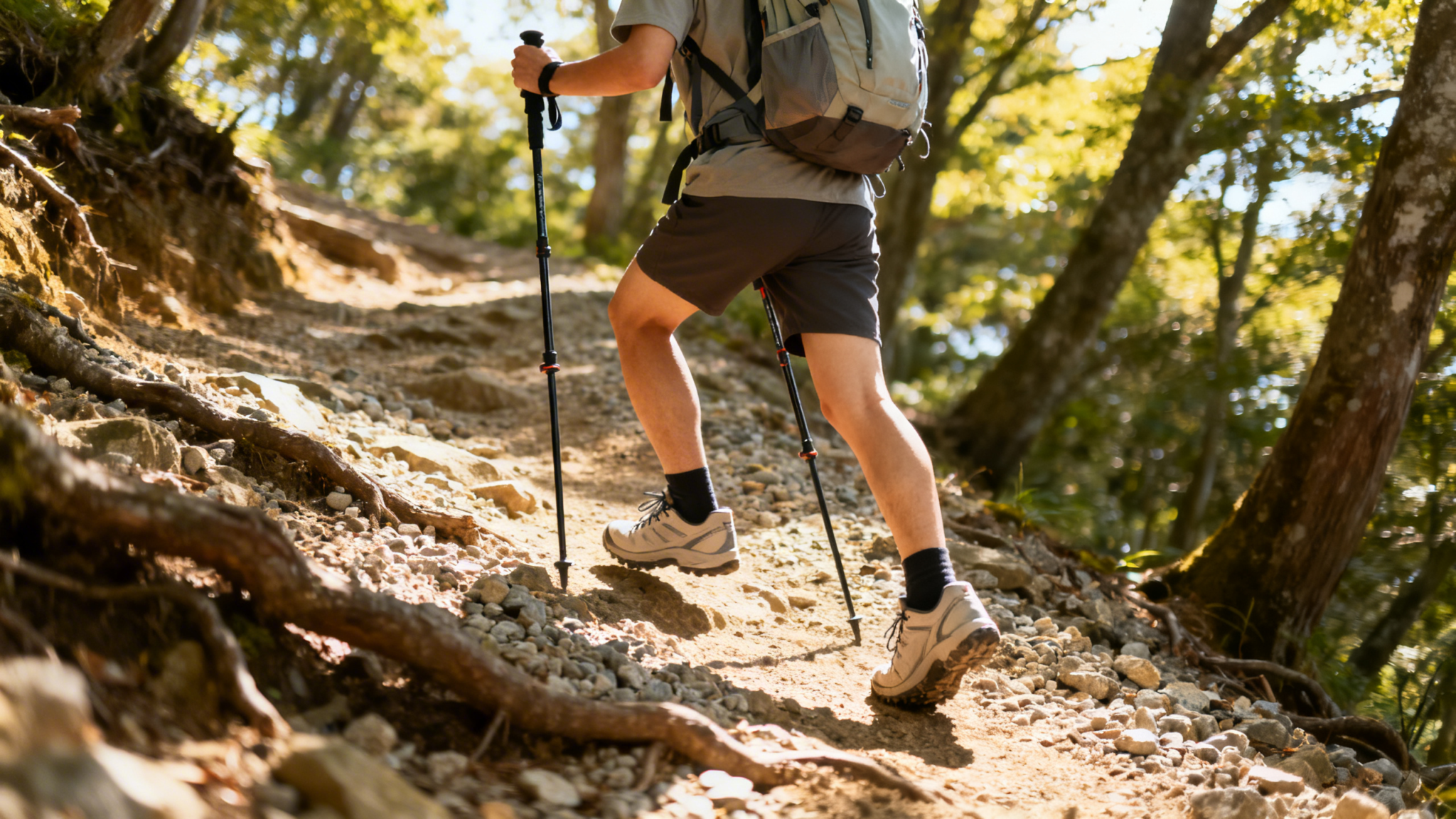 Beginner hiker using adjustable trekking poles on a rocky summer hiking trail for stability and balance.